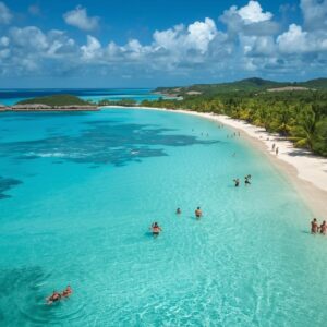 Aerial view of Caribbean islands with turquoise water white sand beaches palm trees bright sky and tourists enjoying the beach and water activities